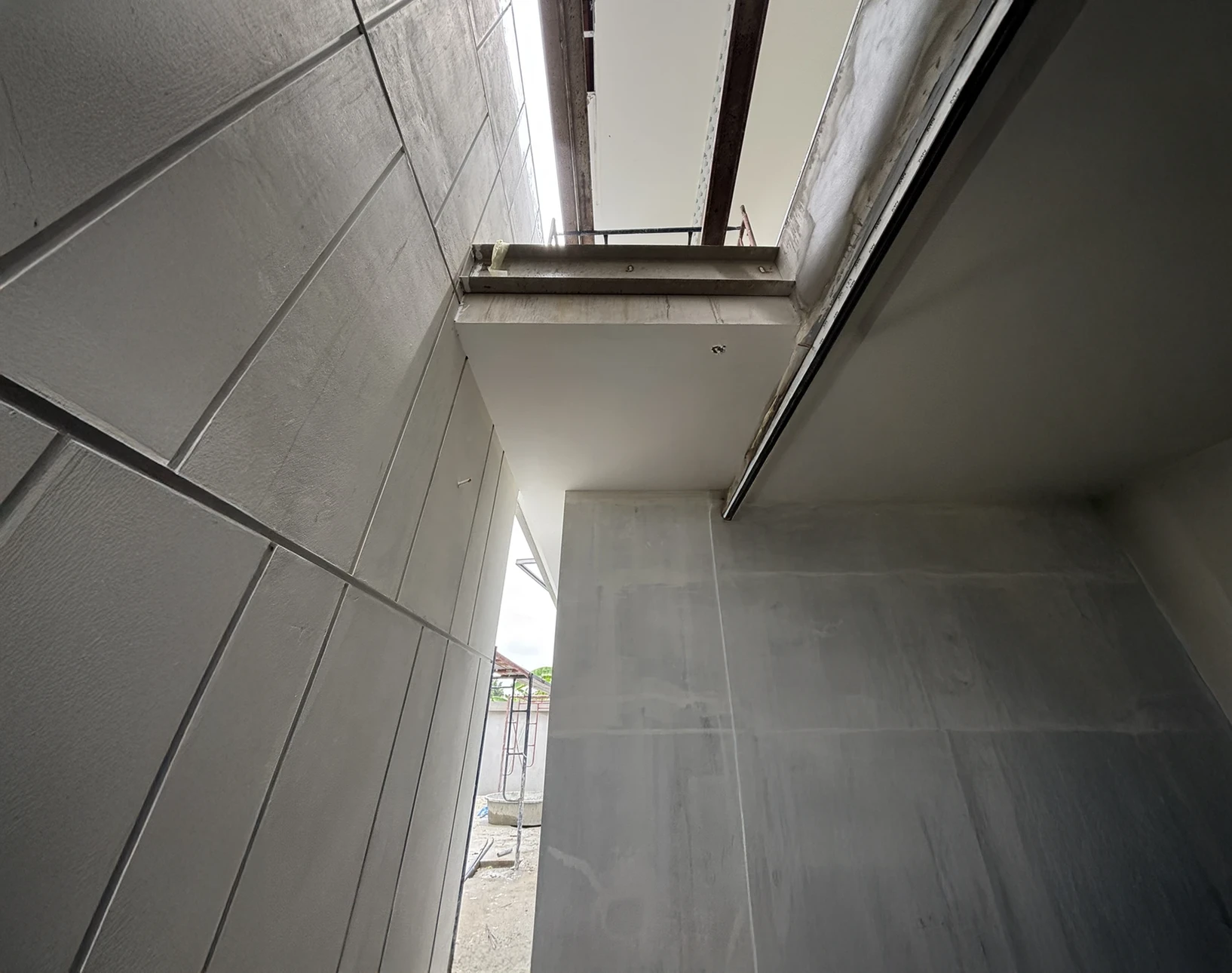 Chantier de construction au coucher du soleil avec ouvriers en gilets de sécurité travaillant autour d'une structure en béton